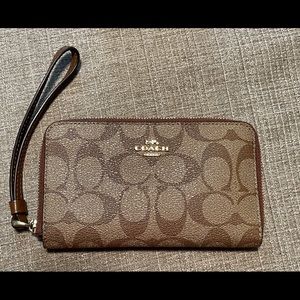 Brown leather coach wristlet.
